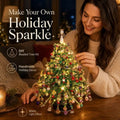 Woman crafting a Christmas Sparkle DIY beaded tree with colorful ornaments, angel topper and warm lights